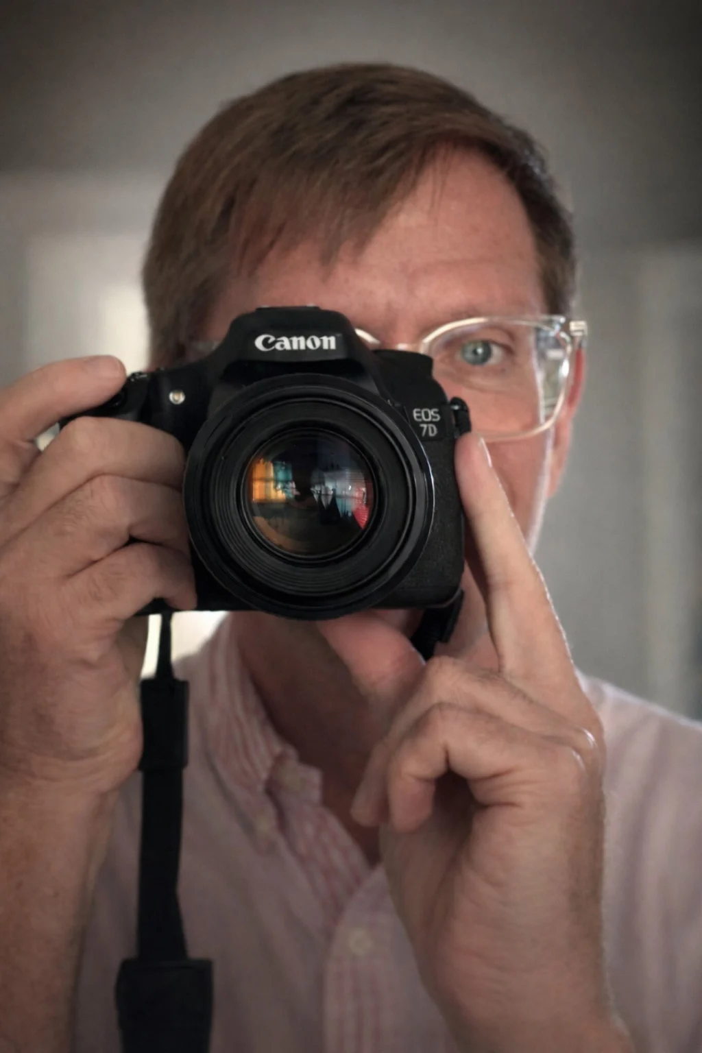 Portrait of Marc Pinter holding a camera.